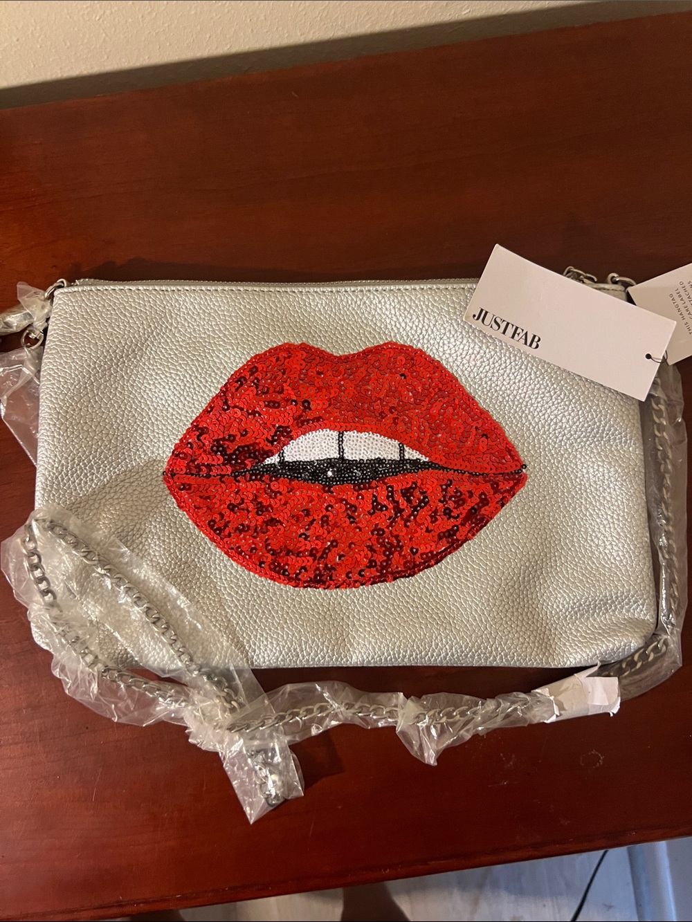 JustFab Silver Crossbody with Red Sequin Lip Applique